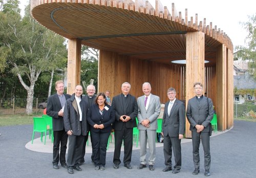 Gruppe von Bistumsvertretern mit Bischof Wiesemann vor dem Kirchenpavillon auf der Landesgartenschau in Landau